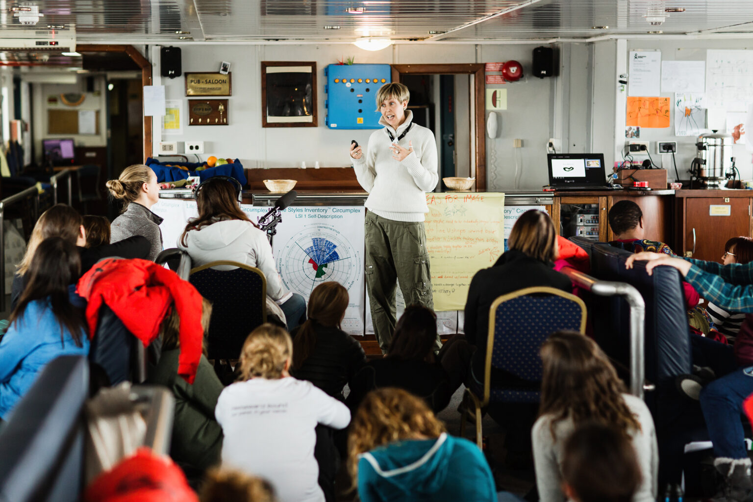 Fern Wickson presenting her research during a “Symposium at Sea” aboard the vessel Ushuaia as part of the Homeward Bound Leadership programme for women in STEMM