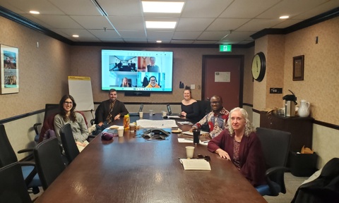 The group is sitting around the table.