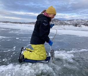 Sediment sampling in water reservoir, Greenland.