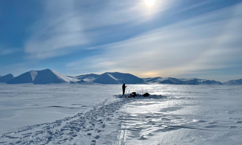A member of Roland Kallenborn’s team takes snow and ice samples in the Arctic. 